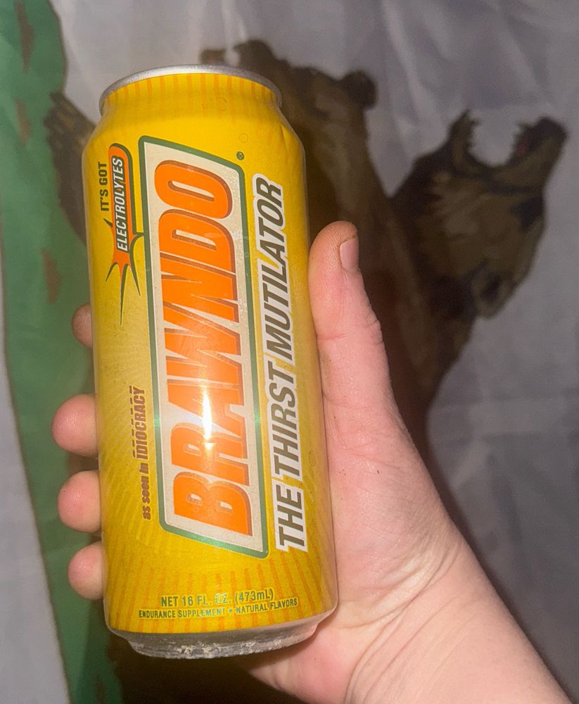 a mayo arm holding up a can of BRAWNDO THE THIRST MUTILATOR 

ITS WHAT PLANTS CRAVE 