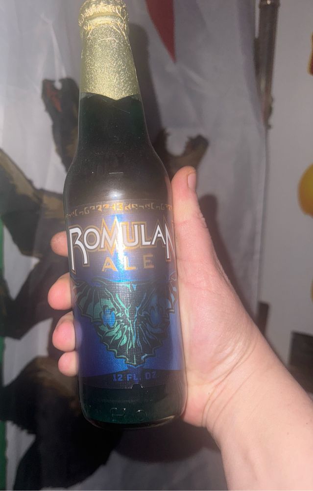 a beer bottle labeled "Romulan Ale" with a blue liquid 