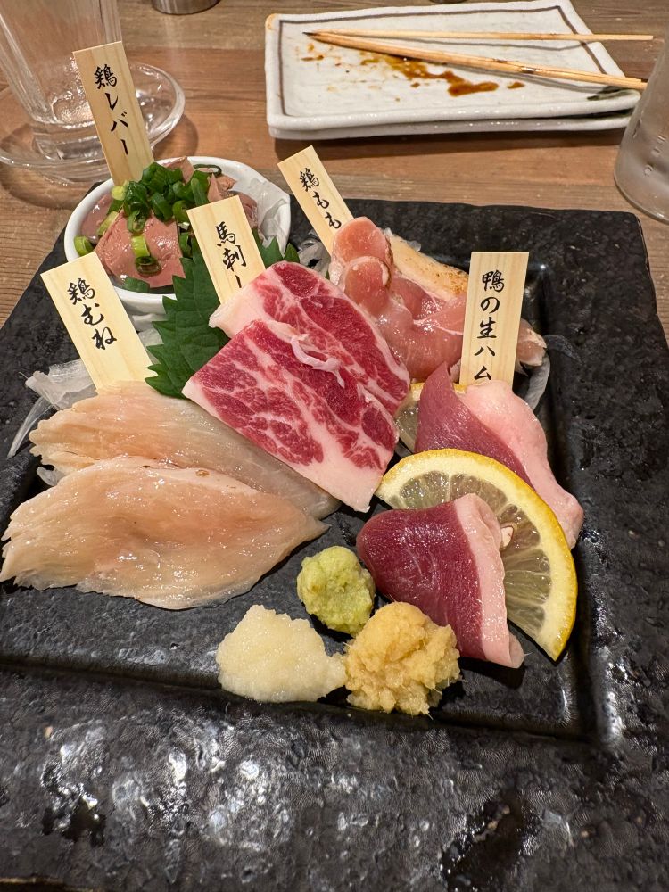 Chicken, horse and duck sashimi on a plate at a 24h Tokyo diner 