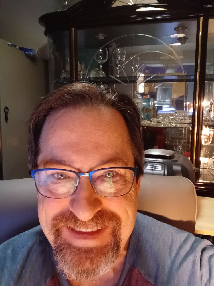 Gentleman with glasses, dark hair, and an evil grin.