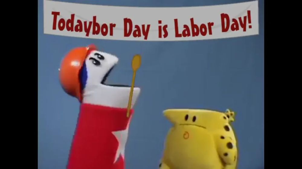 Puppet Homestar and The Cheat stand under a banner declaring that TODAYBOR DAY IS LABOR DAY