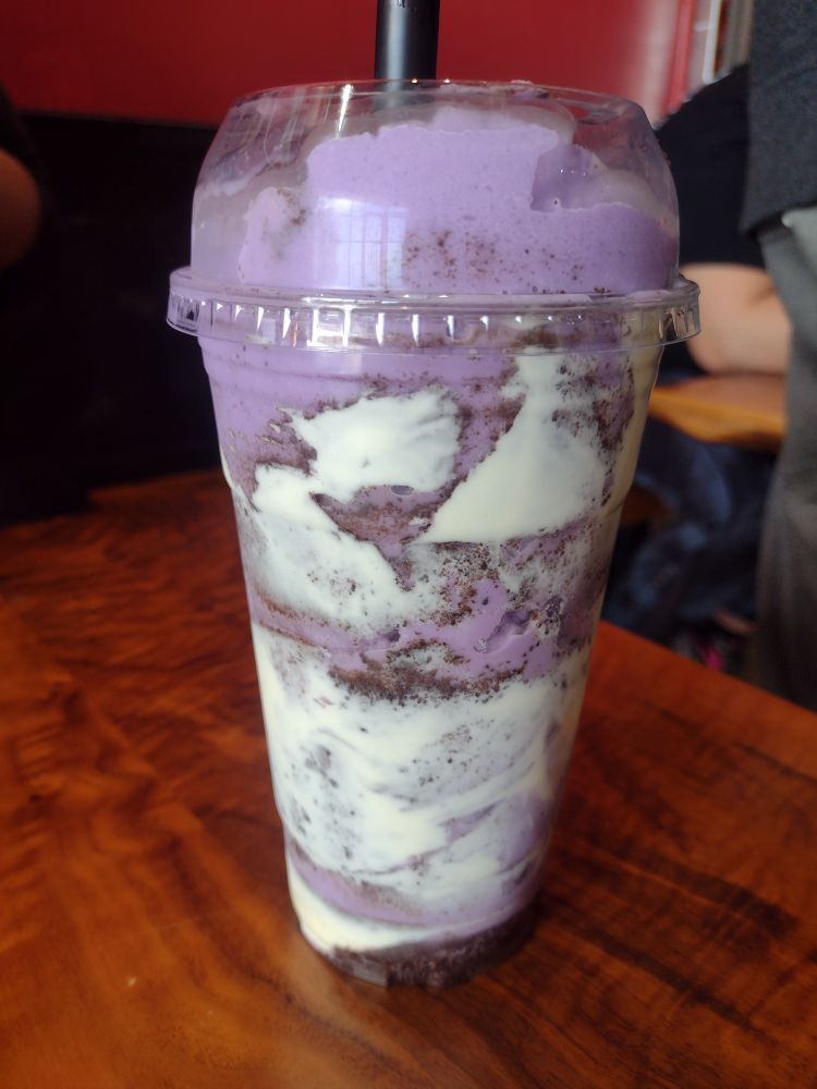An Ube Milkshake with brulee cream and oreo crumbles swirled throughout.