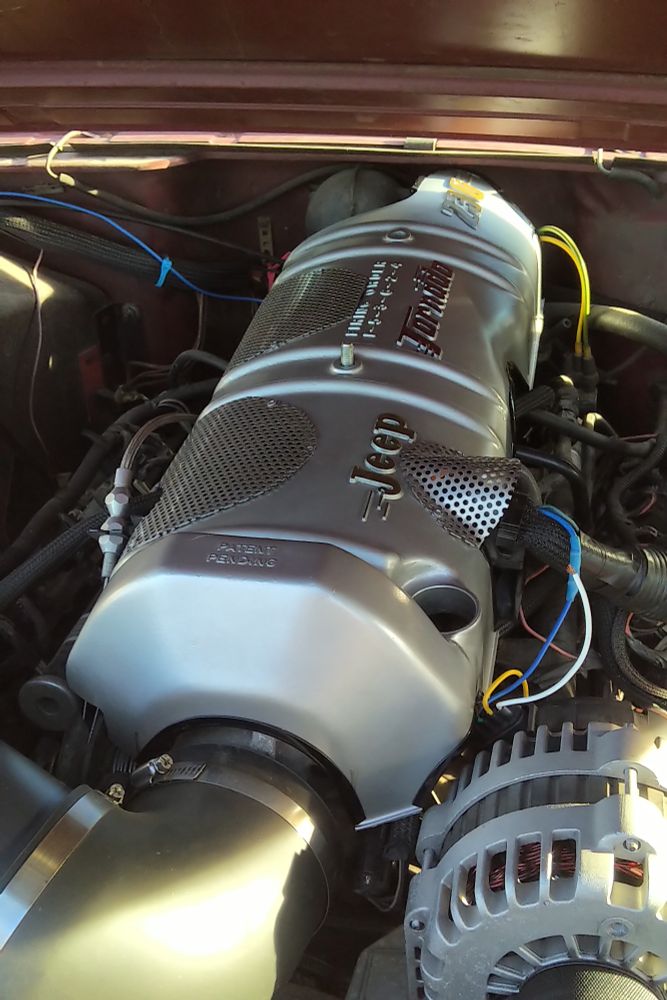 Custom engine cover for a LS motor made from a vintage Jeep Tornado engine's valve cover.