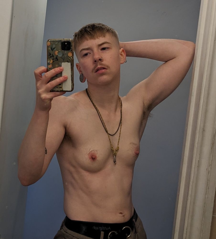 Shirtless guy in the mirror.