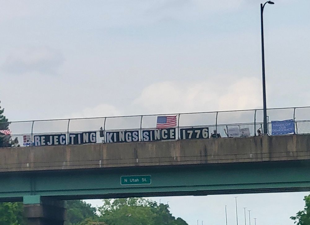 Overpass w protest sign “rejecting Kings Since 1776”