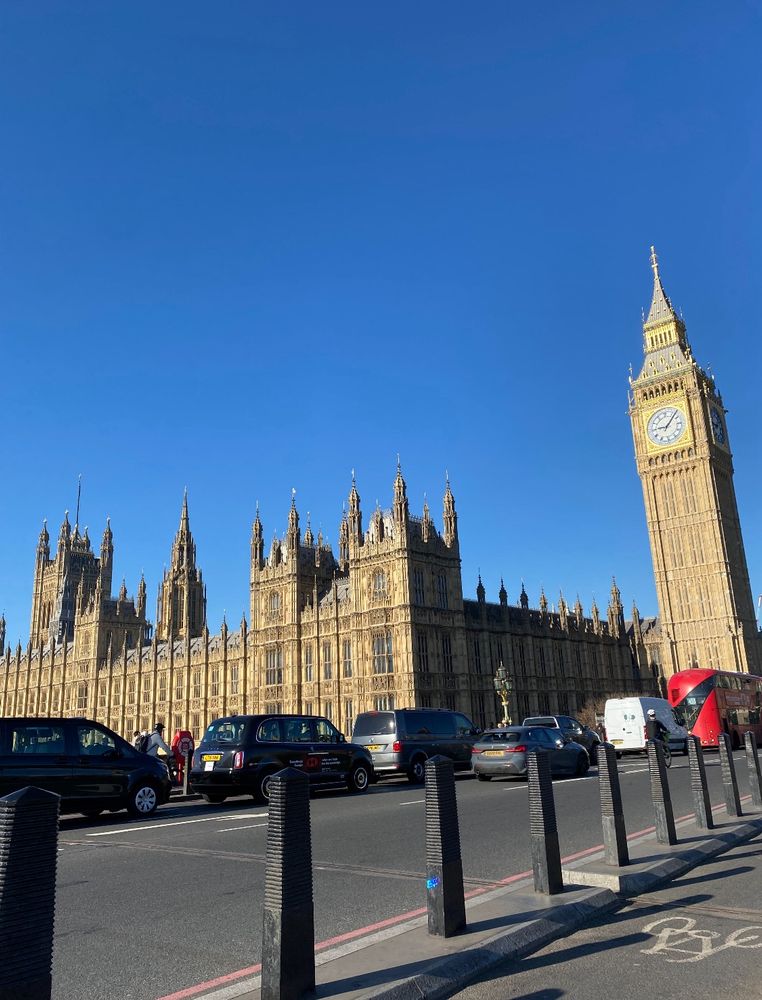 Photo shows the Houses of Parliament and Big Ben against a bright blue sky