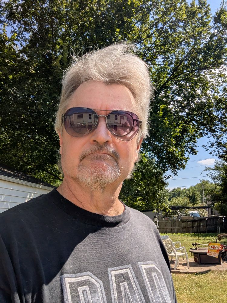 Me wearing a dark T-shirt and freshly quaffed silver foxiness 