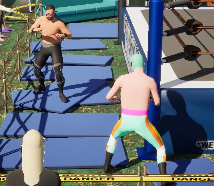 A screenshot from my work in progress wrestling game showing a bunch of floor pads placed down in the grass in a messy way. Some of them are overlapping.
