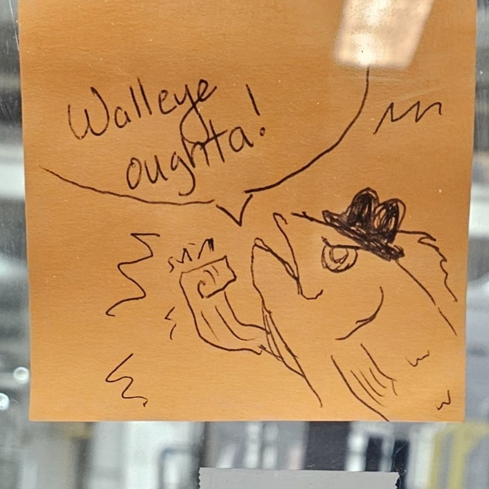 A post-it note with a pen drawing a fish wearing a fedora. It is shaking his fist. A speak bubble says, "Walleye oughta!"