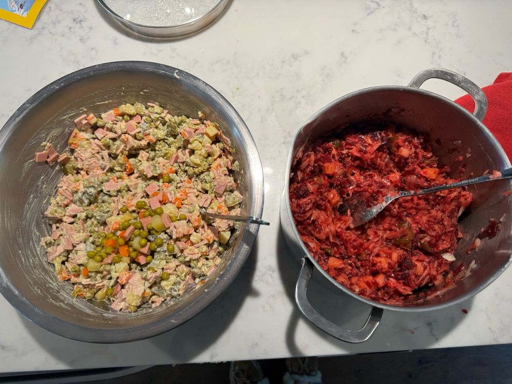 A big bowl and a large pot with Soviet style New Year salads.