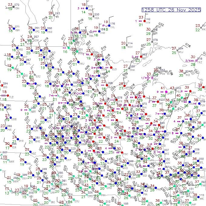 A map of the upper Midwest (ND, SD, NE, MN, IA, WI, IL, IN, MI) depicting weather station current observations (as of 1258 UTC on 26 November) indicating a prominent counter-clockwise circulation of winds now centered - having shifted eastward - over northern Wisconsin and extending outward. 