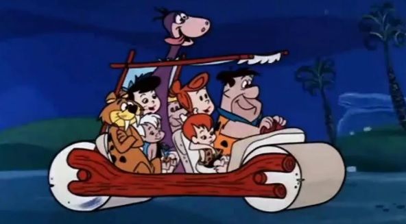 Picture of a modern Stone Age family and friends in a Stone Age car - replete with a purple dinosaur with his head poking up through a hole in the tarp that serves as the car's roof . 