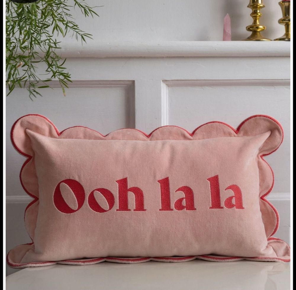 Pink cushion with red writing saying - OOH LA LA
