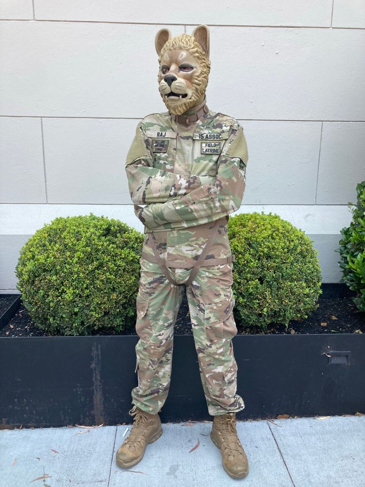 this is wearing a lion mask and US Army gear, except it has a straitjacket made of OCP canvas instead of a normal uniform jacket.