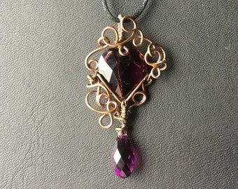 A cute little piece of jewellery made from wire and purble glass 😍