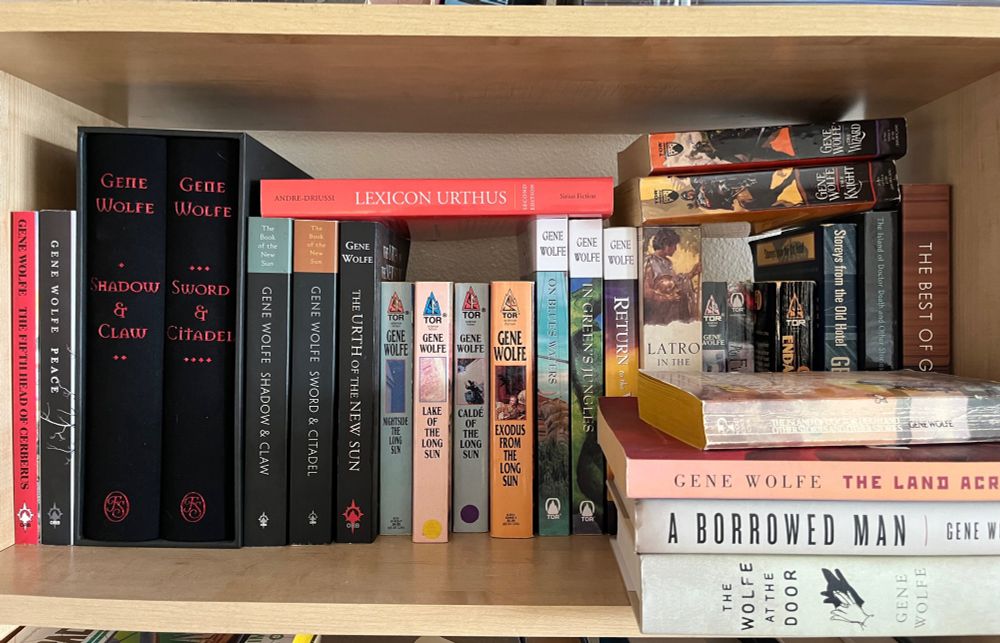 A shelf full of many books written by Gene Wolfe