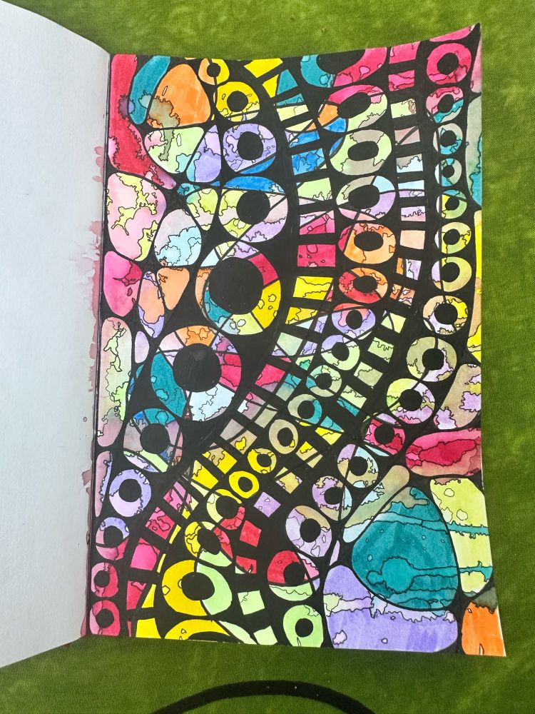 Brightly colored art made with markers overlayed by black patterns. 