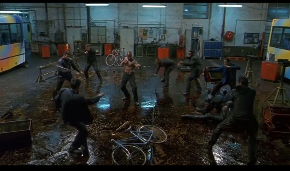 A man covered in oil about to hand a slippery beatdown to a gang of thugs.