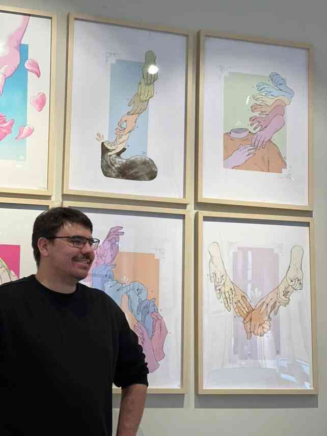 very proud, very jolly frank frank stands in front of his artwork