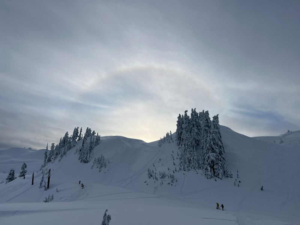 A frostbow above snowy mountain