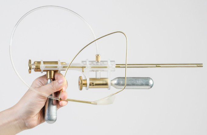 Beautifully designed space-age-llooking gun made from glass, brass and aluminum.