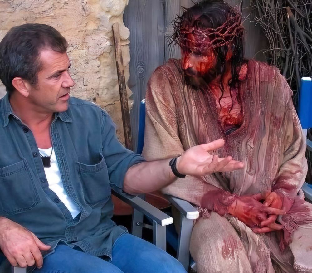 Still from The Passion of Christ, with Cavievel as Jesus, talking to mel gibson 