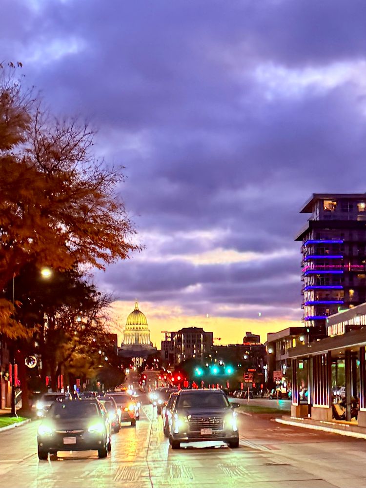 Yellow and purple sunsets on the Capitol in Madison, Wisconsin as you look up east Washington towards the square.