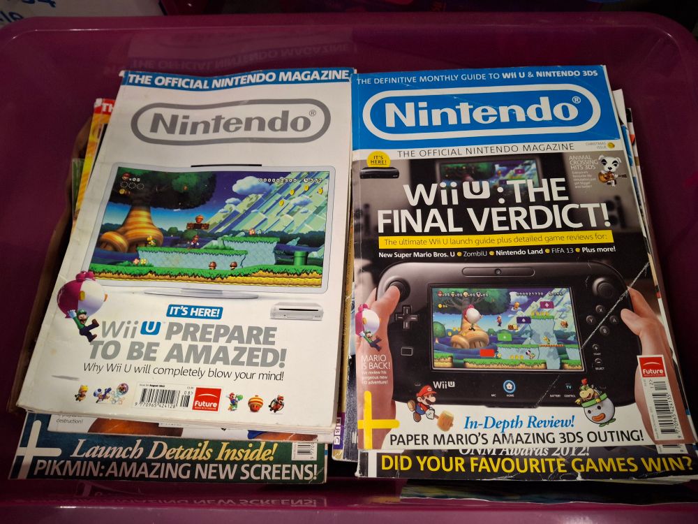 Two issues of Official Nintendo Magazine, both featuring the Wii U as the cover story. "It's here! Wii U, prepare to be amazed!" proclaims one. "Wii U: The Final Verdict" says the other.