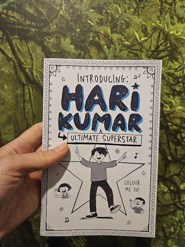 The proof cover of Hari Kumar: Ultimate Superstar. It shows a young boy with fabulous hair dancing in front of a star. Two other children are cheering him on in the background. There's a decorative border and the whole cover is in black and white and says colour me in.