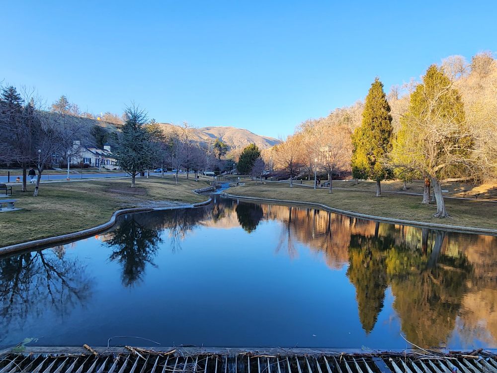 Memory Grove, in Salt Lake City Utah. A creek/spillway for city creek (i think) is featured in the center, reflecting trees and mountains. 