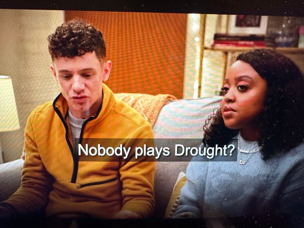 still from an Abbot Elementary episode. two teachers sit on a couch. one teacher says "Nobody plays Drought?"
