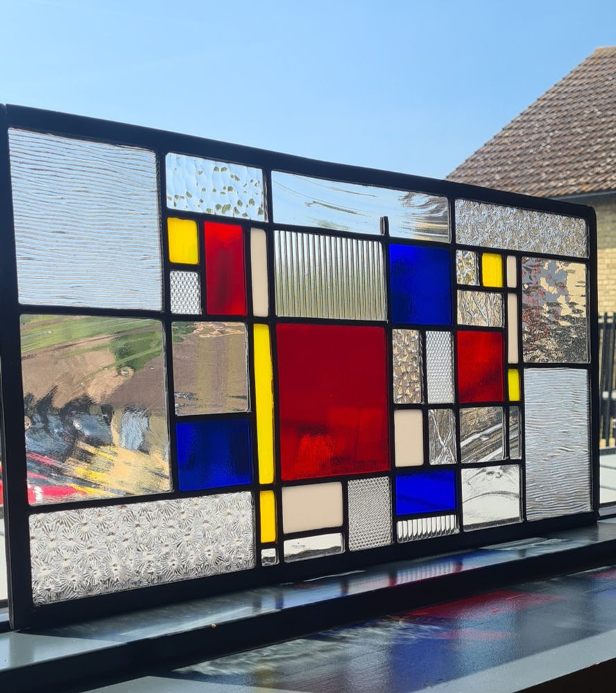 Side view shows textures of clear glass in leaded stained glass panel