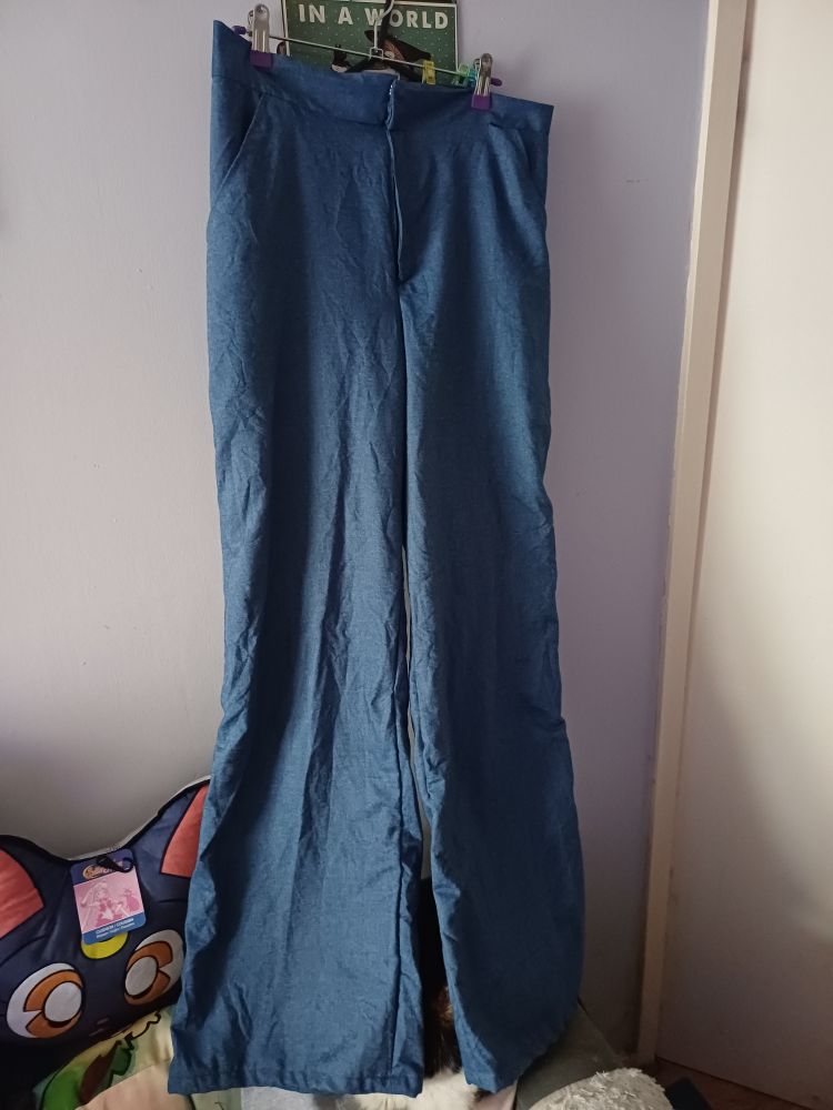 Front Pair of palazzo pant style trousers with zip up fly fastening snd front pockets made from chambray fabric