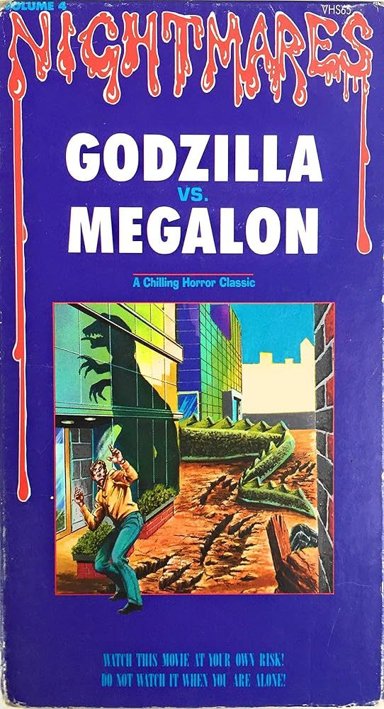 VHS cover for GODZILLA VS. MEGALON featuring an off-model drawing of a tyrannosaurus’ shadow looming over a building. A tagline reads “A chilling horror classic.” A second tagline reads “WATCH THIS MOVIE AT YOUR OWN RISK! DO NOT WATCH IT WHEN YOU ARE ALONE!”
