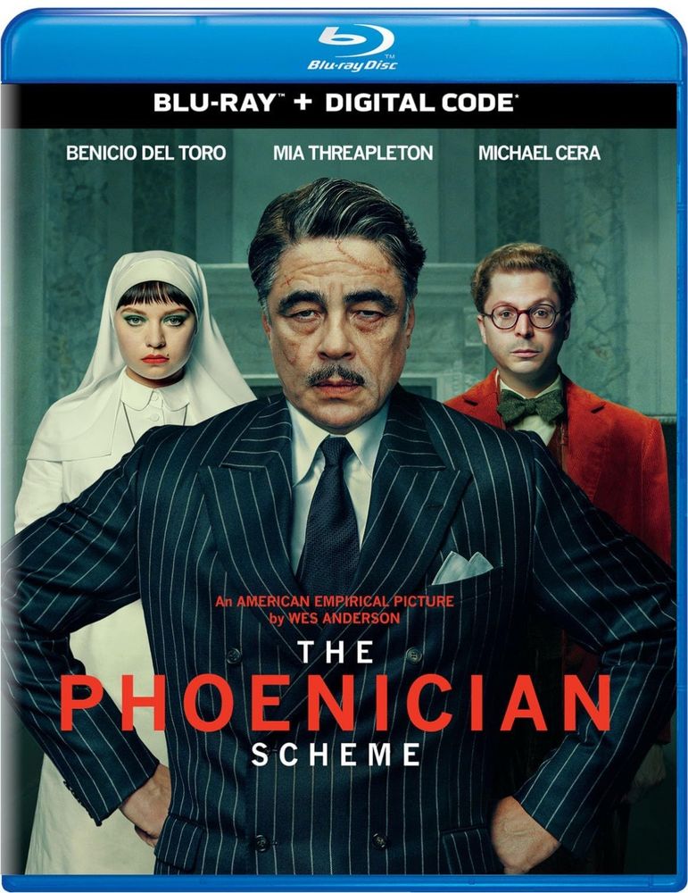 Blu-ray cover art for THE PHOENICIAN SCHEME featuring Benicio del Toro, Mia Threapleton, and Michael Cera glowering at the camera. The image has a weird teal filter reminiscent of the SAW films.