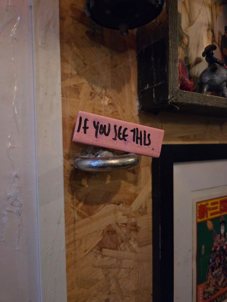 Pink Jenga block on a tiny plinth thing in a bar that says "if you see this"