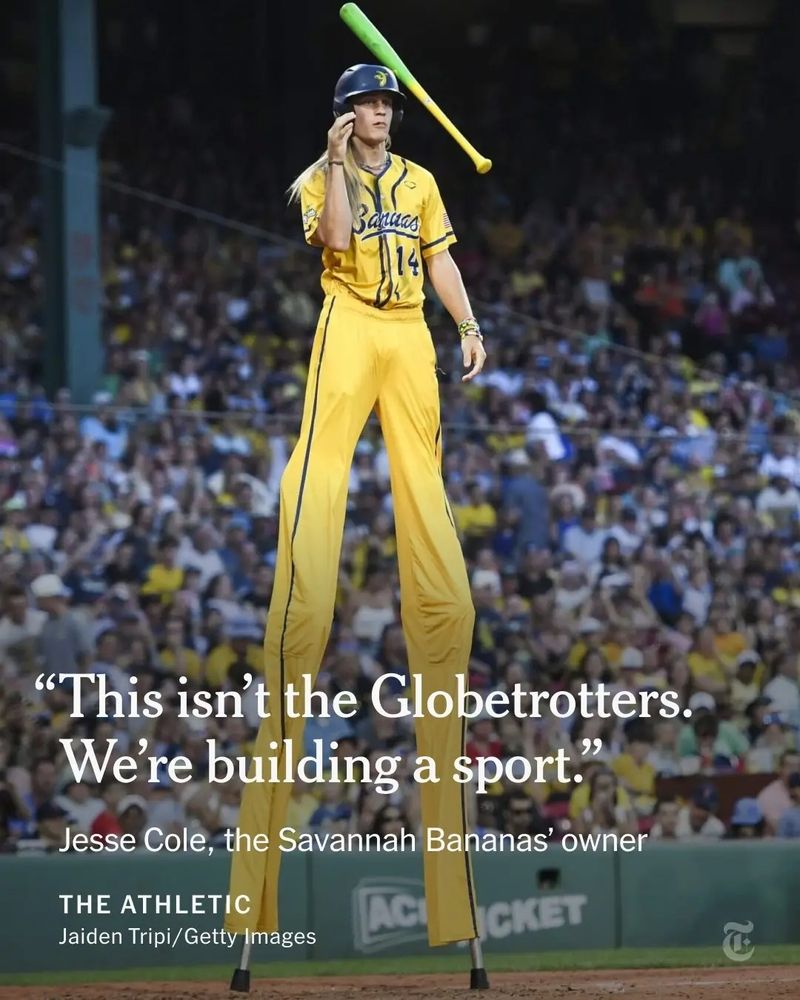 A Savannah Banana on stilts gently tosses a rainbow-colored bat. The text overlay reads: 