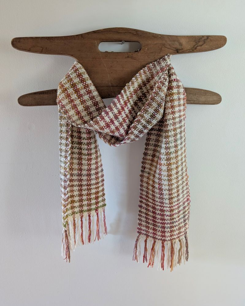 Woven scarf on wooden hanger