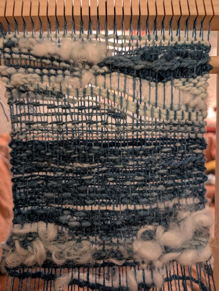 Irregular weaving of a seascape in shades of blue and white.