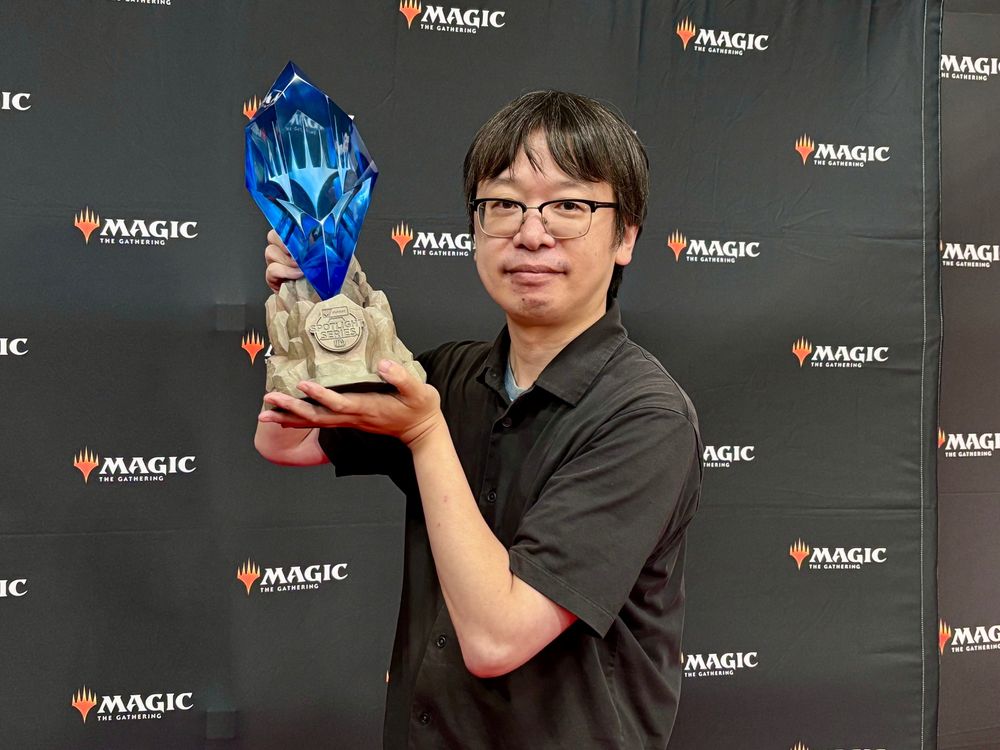 Hirabayashi holds the blue crystal trophy