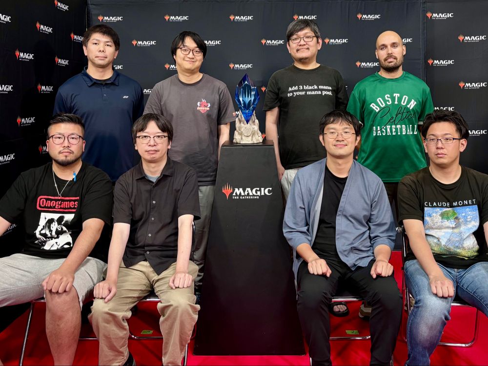 eight players seated around the trophy