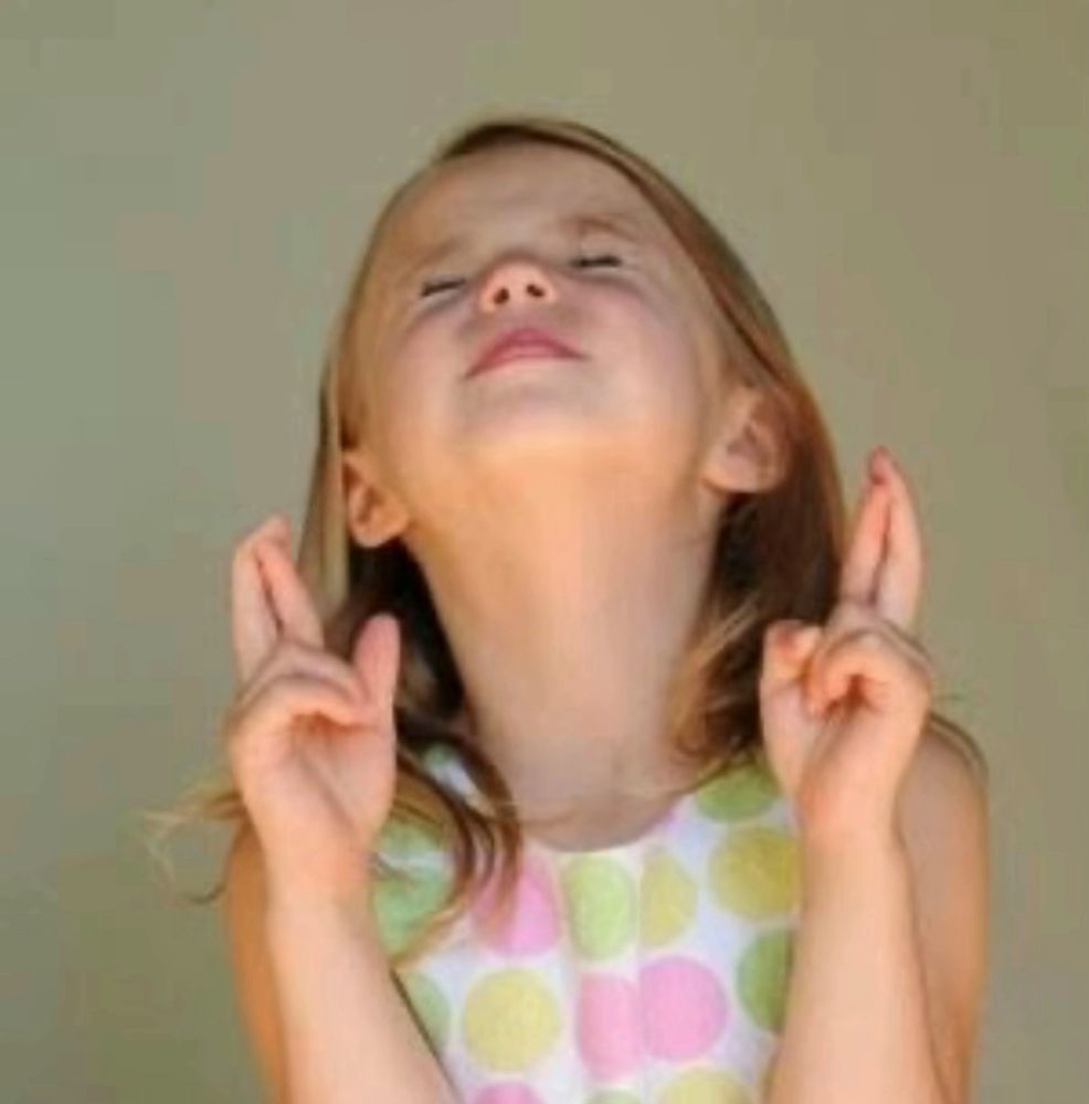 Little girl with her fingers crossed 