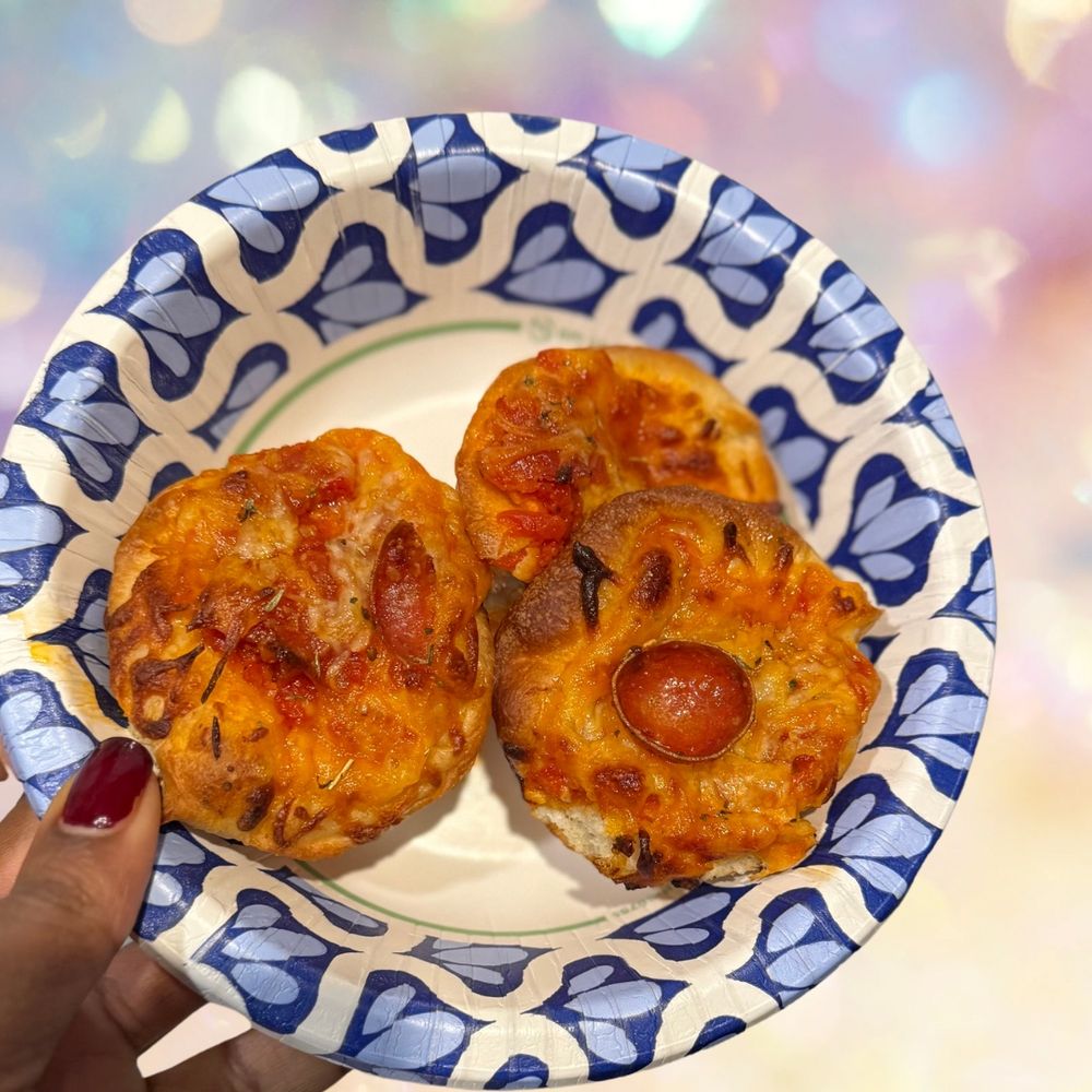 3 pizza puffs with pepperoni in a paper bowl 