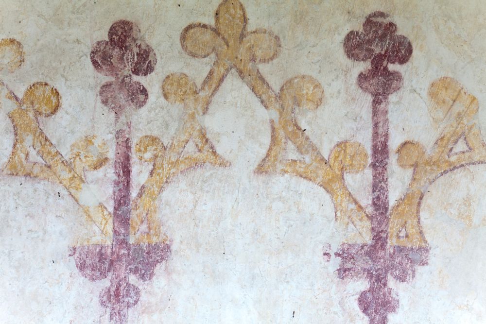 Close up of wall painting of mock reredos, imitating carved wood in red and yellow (c) Andy Marshall