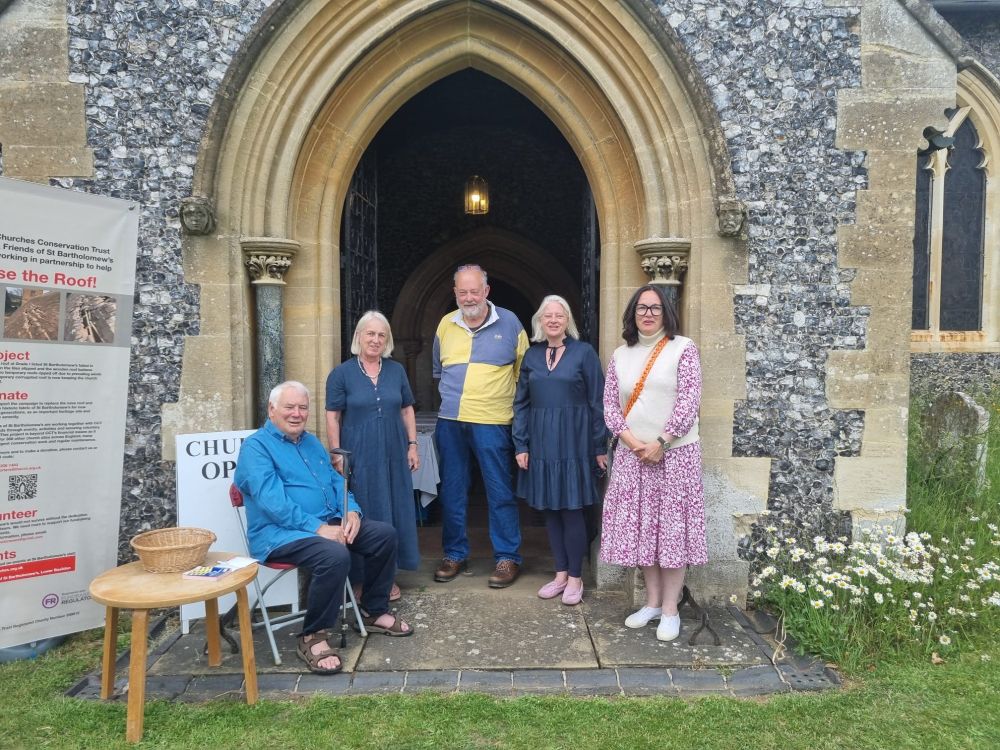 Part of the Lower Basildon team posing for a photo outside the front door of the church
