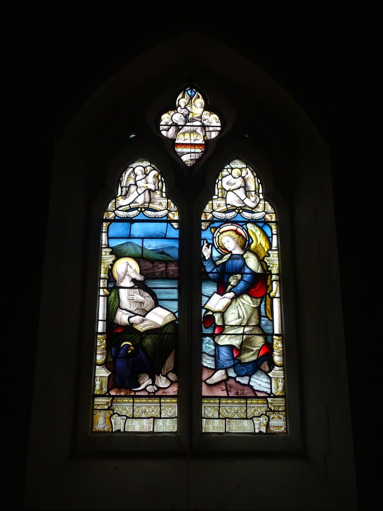 Stained glass window depicting possibly the evangelist John with an eagle, an open book in his lap and an angel bringing him Gods word (c)  Maria Luisa Latorre