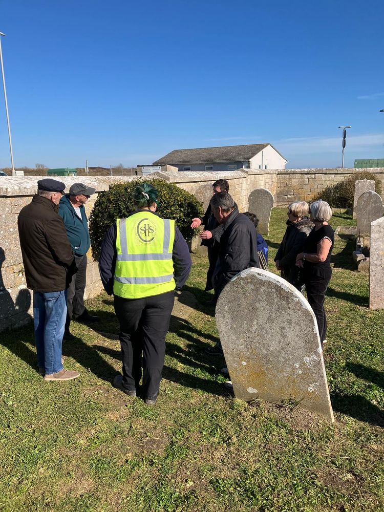 Friends and conservators engaged in conversation in the churchyard.