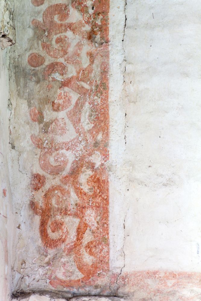 Swirly border of a frame painted onto the walls of St. Thomas A Becket in red. Image (c) Andy Marshall