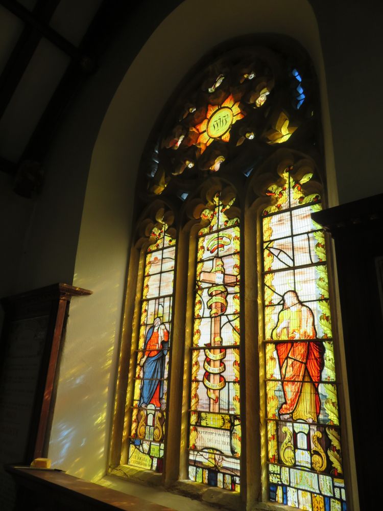 Stained glass window at Low Ham church, mainly yellow glass, a sun panel at the top and beneath it three panels showing Mary, the cross and Jesus (c) Andrew Faulkner