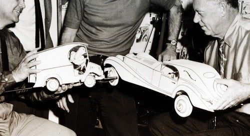 Animators playing with cardboard cars